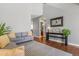 Cozy living room area showcasing hardwood floors, gray sofas, and tasteful interior design at 6852 S Algonquian Ct, Aurora, CO 80016