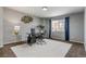 Office space with a sleek desk and a light-filled window, ideal for a work-from-home setup at 6852 S Algonquian Ct, Aurora, CO 80016