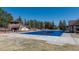 Community swimming pool completely covered with a winter tarp at 6852 S Algonquian Ct, Aurora, CO 80016