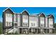 Modern townhouse exterior featuring a stylish combination of gray siding and brick accents at 694 Saddle Dr, Erie, CO 80516
