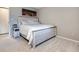 Comfortable bedroom with a whitewashed wood bed frame, neutral walls, and soft carpeting at 4068 S Atchison Way # 101, Aurora, CO 80014