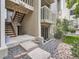 Condo exterior showcasing stairwell, balcony, sliding glass doors, and rock landscaping at 4068 S Atchison Way # 101, Aurora, CO 80014