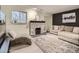 Inviting living room featuring a stone fireplace, neutral color palette, and comfortable seating arrangement at 4068 S Atchison Way # 101, Aurora, CO 80014