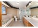 Bathroom with a bathtub, glass enclosed shower, vanity, and a window with a view at 10650 Yellowstone Rd, Longmont, CO 80504