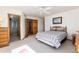 Well-lit bedroom with a large bed, ceiling fan, and access to an ensuite bathroom at 10650 Yellowstone Rd, Longmont, CO 80504