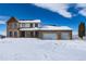 Charming two-story home with a two-car garage nestled in a snow-covered landscape at 10650 Yellowstone Rd, Longmont, CO 80504