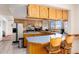 Eat-in kitchen with oak cabinets, an island with barstools, and lots of counter space at 10650 Yellowstone Rd, Longmont, CO 80504