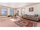 Inviting living room with plenty of natural light, vintage furniture, and a colorful rug at 10650 Yellowstone Rd, Longmont, CO 80504