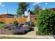Backyard featuring a patio set, lovely garden beds, and a tall wooden fence at 1363 Stuart St, Denver, CO 80204