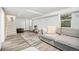 Spacious basement with a seating area, large area rug, stairs, and storage at 1363 Stuart St, Denver, CO 80204