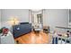Bright bedroom featuring hardwood floors, a large window with curtains, and ample space at 1363 Stuart St, Denver, CO 80204