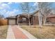 Brick home with attached garage and cozy front porch and well-maintained landscaping at 1363 Stuart St, Denver, CO 80204