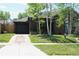 Brick home featuring a front yard, driveway, and a cozy front porch at 1363 Stuart St, Denver, CO 80204