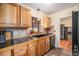 Well-equipped kitchen featuring custom wood cabinets, stone tile backsplash, and a black sink at 1363 Stuart St, Denver, CO 80204