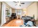 A comfortable living room with hardwood floors, windows, and a ceiling fan at 1363 Stuart St, Denver, CO 80204