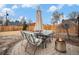 Outdoor dining area with an umbrella, fire pit, and patio furniture set on a brick-paved backyard at 1363 Stuart St, Denver, CO 80204