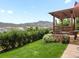Charming backyard with a pergola, lush lawn, beautiful landscaping and mountain views at 15264 W La Salle Ave, Lakewood, CO 80228