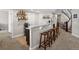 Basement bar area featuring granite countertops, barstool seating, and convenient beverage storage at 15264 W La Salle Ave, Lakewood, CO 80228