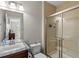 Bathroom with double sink vanity, granite countertops and a tiled walk-in shower with glass door at 15264 W La Salle Ave, Lakewood, CO 80228