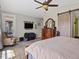 Cozy primary bedroom featuring wood floors, ceiling fan, sliding barn door, and a private access door to the backyard at 15264 W La Salle Ave, Lakewood, CO 80228