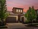 Charming stucco two-story home with a tiled roof, stone accents, mature landscaping, and a two-car garage at 15264 W La Salle Ave, Lakewood, CO 80228