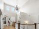 Bright foyer with soaring ceilings, chandelier, and decorative staircase with white spindles and wood accents at 15264 W La Salle Ave, Lakewood, CO 80228