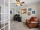 Inviting home office with chair, desk, built-in cabinets, overhead lighting, and a comfortable seating area with a leather chair at 15264 W La Salle Ave, Lakewood, CO 80228