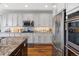 Bright kitchen boasts stainless appliances, granite counters and tile backsplash at 15264 W La Salle Ave, Lakewood, CO 80228