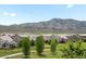 Scenic landscape featuring manicured lawns, mature trees, and the mountains in the distance at 15264 W La Salle Ave, Lakewood, CO 80228