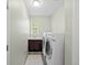 The functional laundry room has a sink and front loading machines at 15264 W La Salle Ave, Lakewood, CO 80228