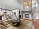 Bright and airy living room flows into the kitchen with hardwood floors and a stone fireplace at 15264 W La Salle Ave, Lakewood, CO 80228