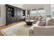 Spacious living room with hardwood floors, large bookcase, neutral decor and stunning mountain views at 15264 W La Salle Ave, Lakewood, CO 80228