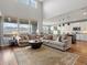 Open concept living room with hardwood floors, neutral decor, and large windows with mountain views at 15264 W La Salle Ave, Lakewood, CO 80228
