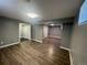 Spacious basement with vinyl plank flooring and neutral paint; includes access to other rooms in the house at 6139 S Adams Dr, Centennial, CO 80121
