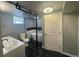 Chic bathroom with freestanding tub, vessel sink, black tile flooring, and modern fixtures, with a chandelier at 6139 S Adams Dr, Centennial, CO 80121