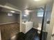 Modern bathroom with double vanity, separate toilet, freestanding tub, and access to a room with vinyl floors at 6139 S Adams Dr, Centennial, CO 80121
