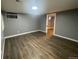 Cozy bedroom featuring vinyl plank flooring, with window and closet access, and a neutral paint scheme at 6139 S Adams Dr, Centennial, CO 80121