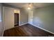 Bedroom with hardwood floors features a closet and adjacent doorway at 6139 S Adams Dr, Centennial, CO 80121