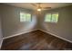 Bedroom with hardwood floors has two windows allowing natural light at 6139 S Adams Dr, Centennial, CO 80121