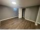 A neutral-toned bedroom featuring vinyl plank flooring, white trim, a closet, and access to other rooms at 6139 S Adams Dr, Centennial, CO 80121