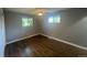 Cozy bedroom with hardwood floors, ceiling fan, and windows allowing natural light at 6139 S Adams Dr, Centennial, CO 80121