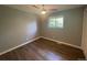 Bedroom with hardwood floors features a window and closet at 6139 S Adams Dr, Centennial, CO 80121