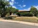 Attractive single story brick home featuring well-kept landscaping and mature trees at 6139 S Adams Dr, Centennial, CO 80121