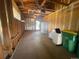 Open garage with concrete flooring and ample storage space; includes a refrigerator and washing machine at 6139 S Adams Dr, Centennial, CO 80121