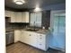 A modern kitchen features white cabinets, sleek countertops, and stainless-steel appliances at 6139 S Adams Dr, Centennial, CO 80121