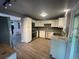 Updated kitchen features stainless steel appliances, stylish backsplash, and ample countertop space at 6139 S Adams Dr, Centennial, CO 80121