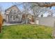 Fenced backyard features a deck, a patio, and mature trees at 321 S Emerson St, Denver, CO 80209