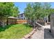 Landscaped backyard with a deck and mature trees at 321 S Emerson St, Denver, CO 80209
