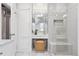 Elegant bathroom with a glass enclosed shower, a vanity with mirror, and a woven stool at 321 S Emerson St, Denver, CO 80209