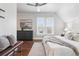 Bright bedroom featuring hardwood floors, modern decor, and natural light from a large window at 321 S Emerson St, Denver, CO 80209